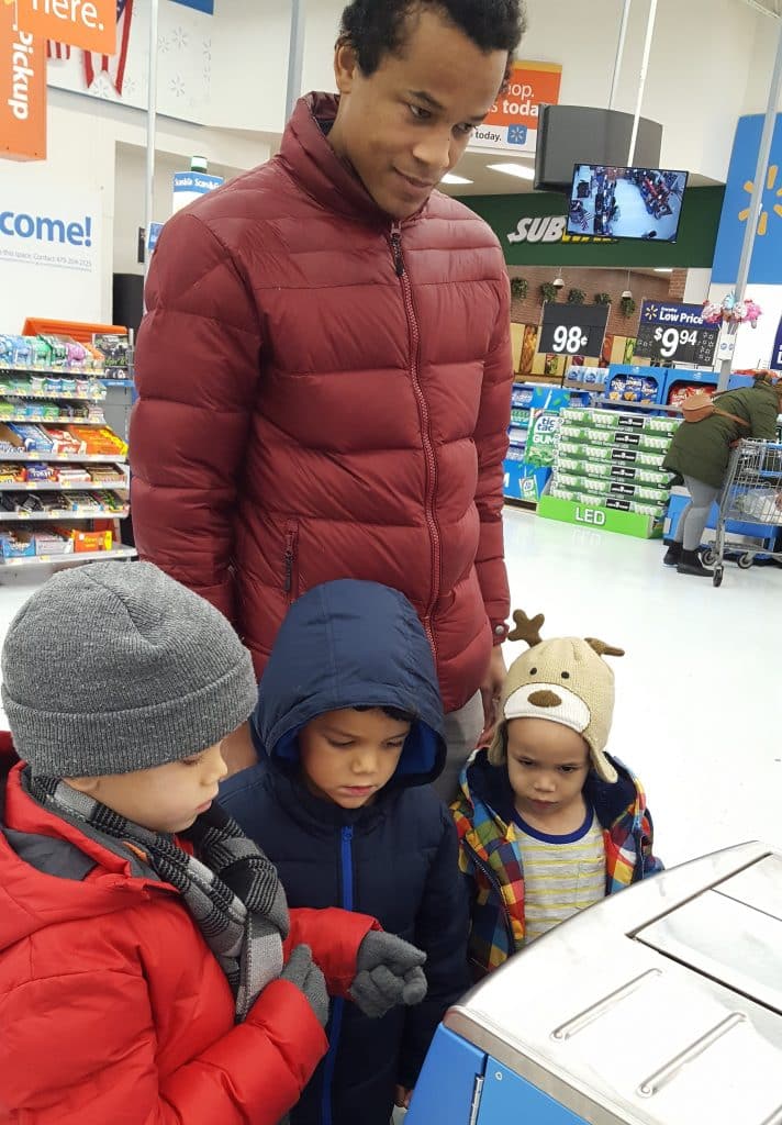 father at Walmart self-checkout with three kids before deciding to boycott the store