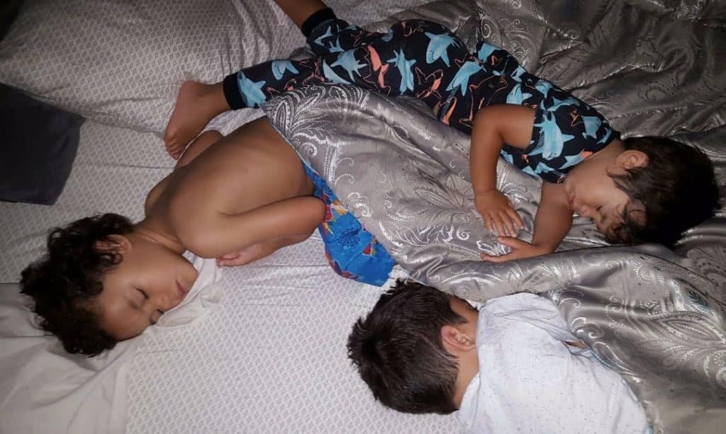 toddlers co-sleeping on top of each other 