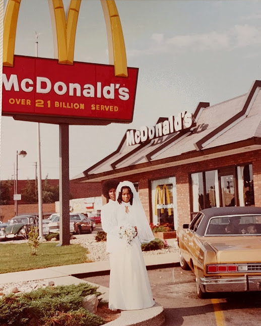 Couple standing outside of the McDonald's they were married in