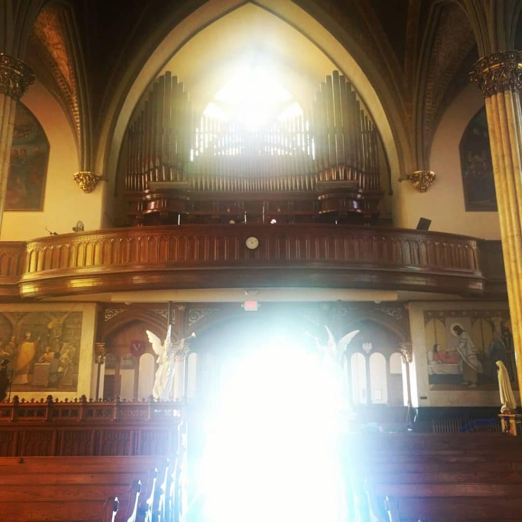 The pews with sun shining in Sweetest Heart of Mary Roman Catholic Church in Detroit 