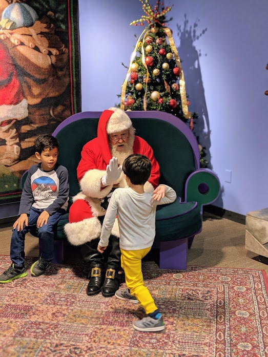 Santa Claus giving kid high-five at Children's Museum of Indianapolis