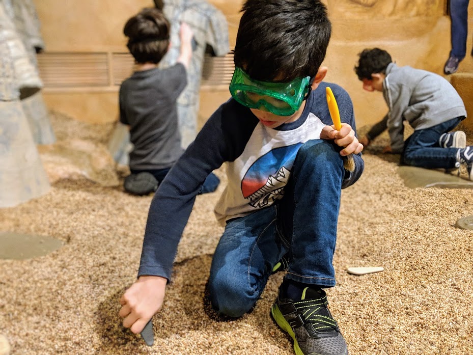 kids digging for terra-cotta warrior replicas in Children's Museum of Indianapolis