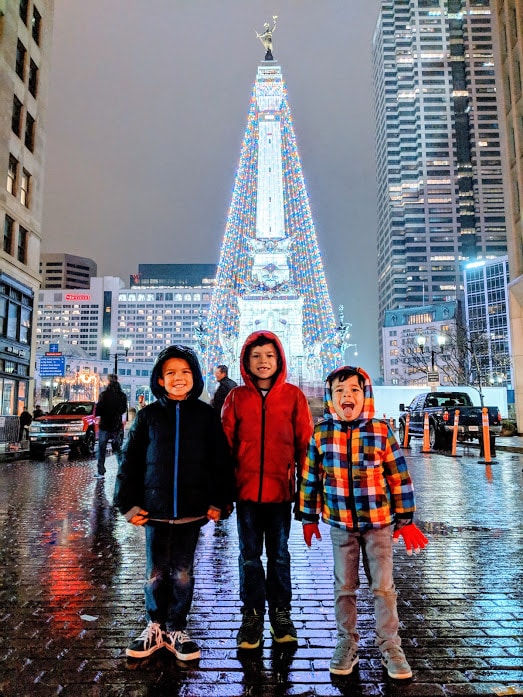 Children posing in rain near Soldiers and Sailors monument in Downtown Indianapolis, Indiana. 