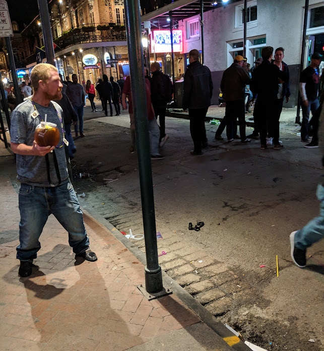 Drunken man on Bourbon Street about to tip over
