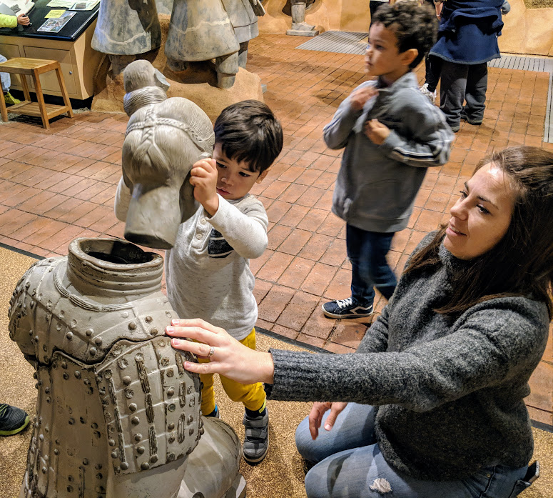 Kids reassembling replicas of terra cotta warriors at the Children's Museum of Indianapolis