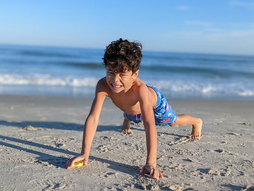 kid doing pushups at Carolina Beach