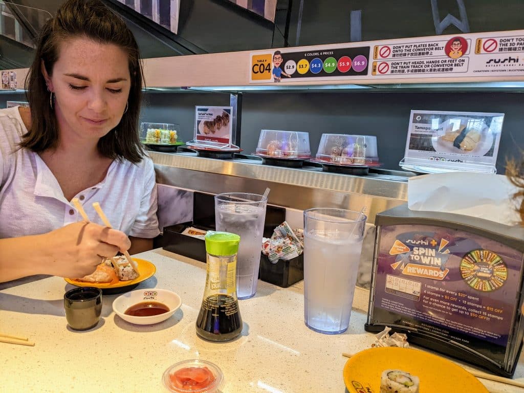 Author's wife eating a rotating sushi restaurant in Chicago;s Chinatown. 