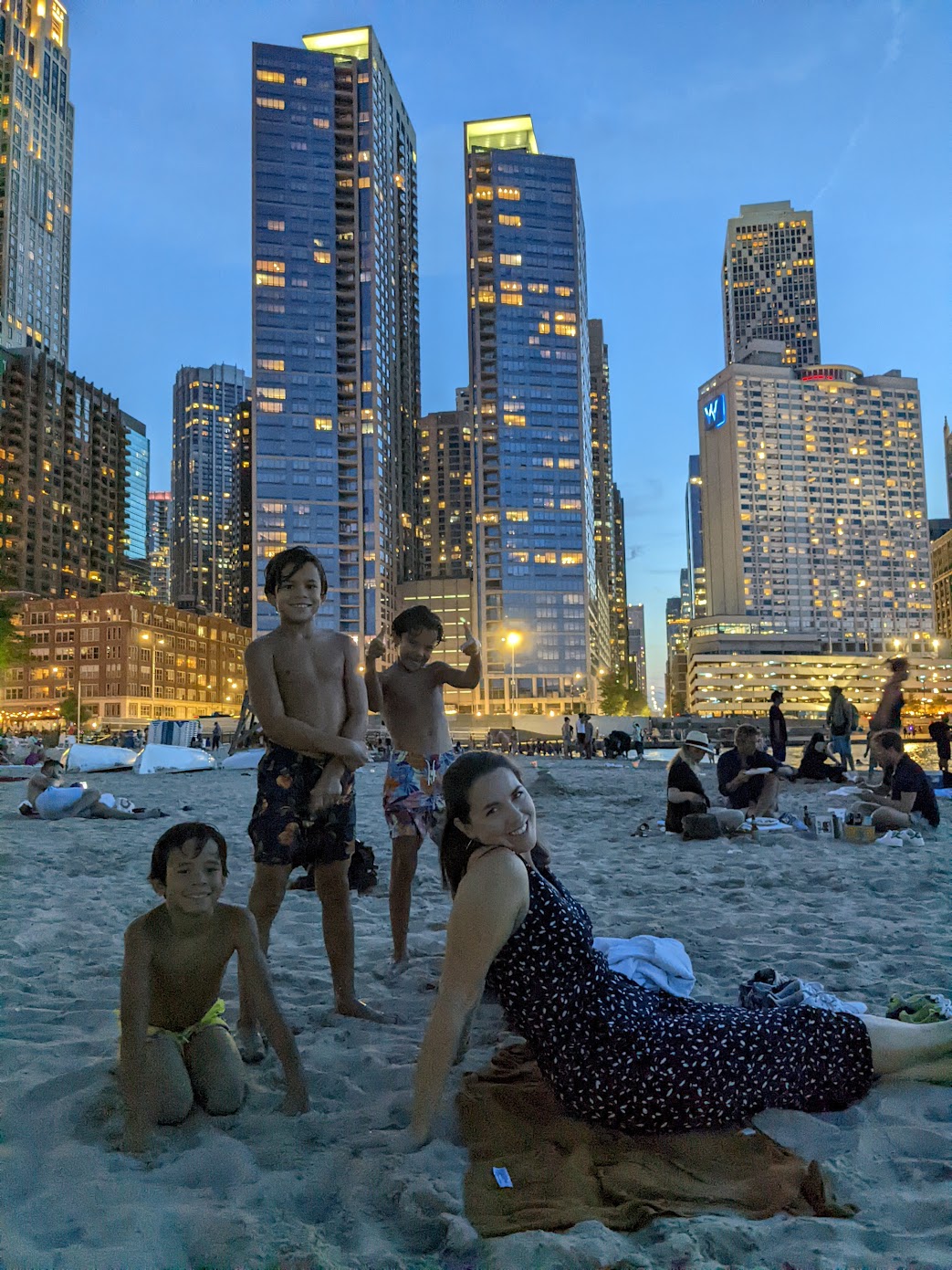 The Gibson wife and kids on the Ohio Street Beach sand at night