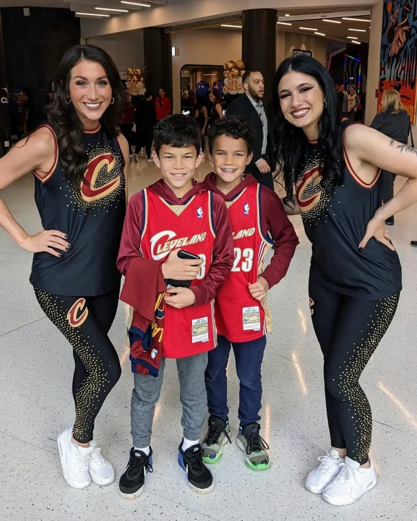 The Gibson boys posing with two members of the Cleveland Cavaliers dance team. 