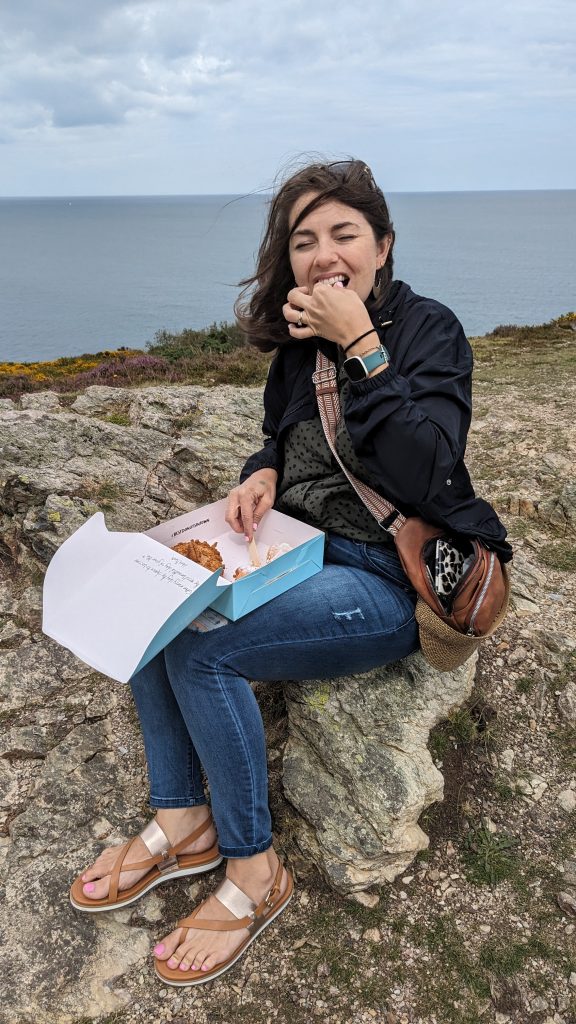 woman eating donuts on howth head peak, Ireland 