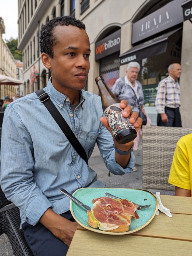 Black man eating smoked meat and avocado in Bilbao, Spain 
