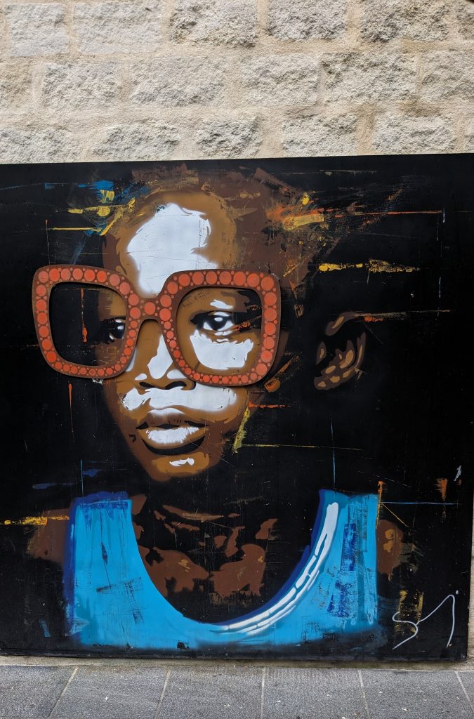 Black girl with red glasses street art in Bordeaux, France