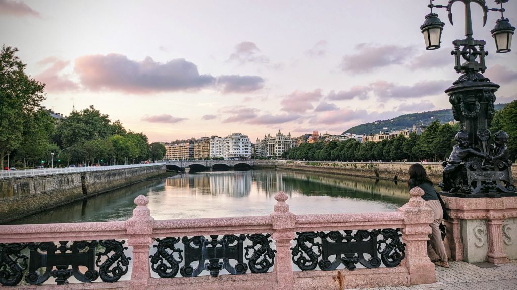 Body of water surrounded by pink railing in San Sebastian, Spain