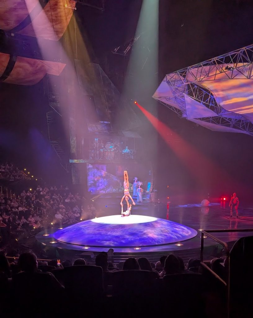 Performer holding acrobat by her feet at Cirque Du Soleil Mystere. 