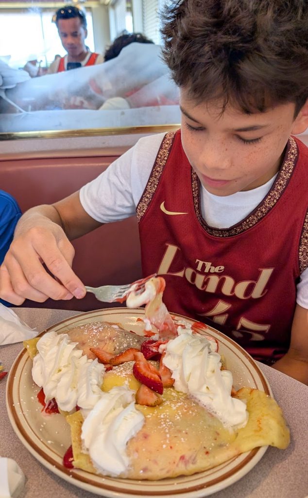 Kid eating crepes at Blueberry Hill restaurant in Las Vegas. 