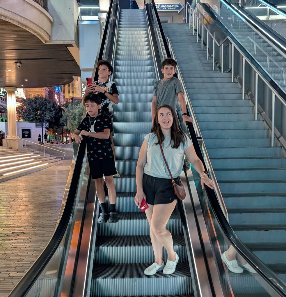 Family going down escalator on Vegas Strip. 