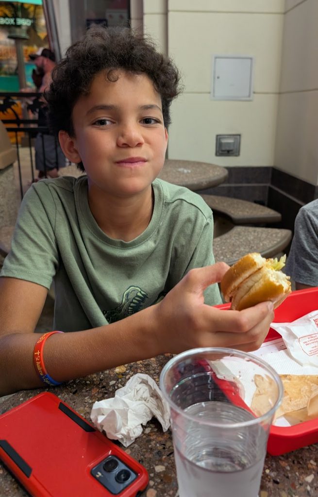 Kid eating an In-N-Out burger near the Vegas Strip. 