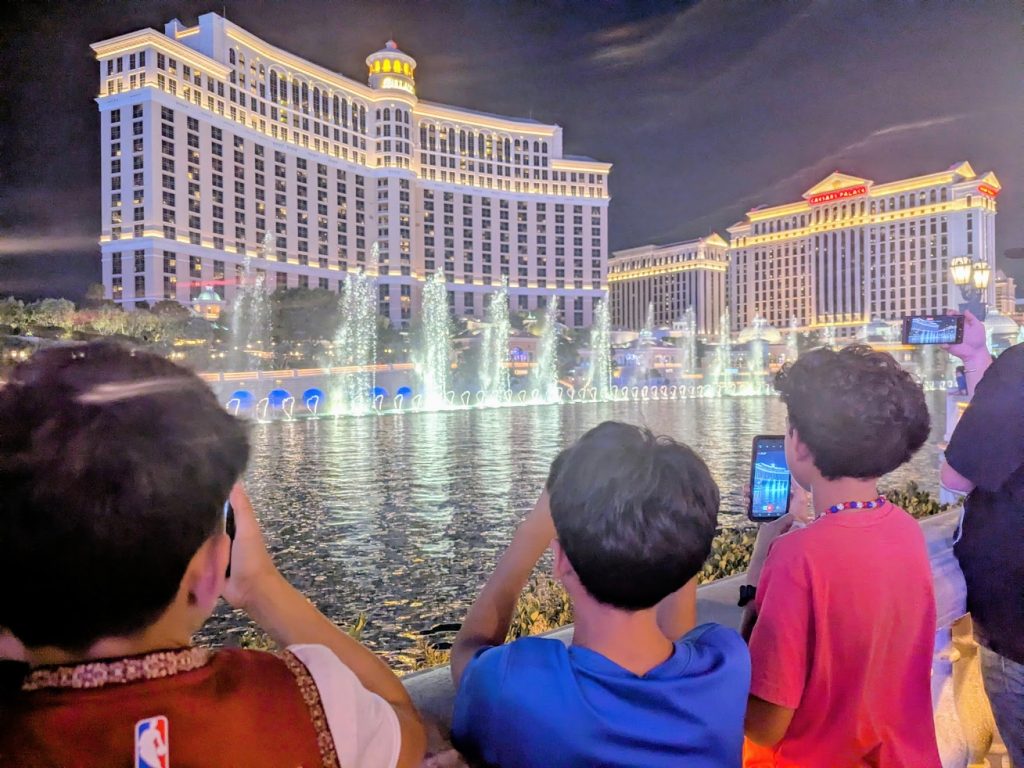 Kids filming the water show outside of the Bellagio in Las Vegas. 