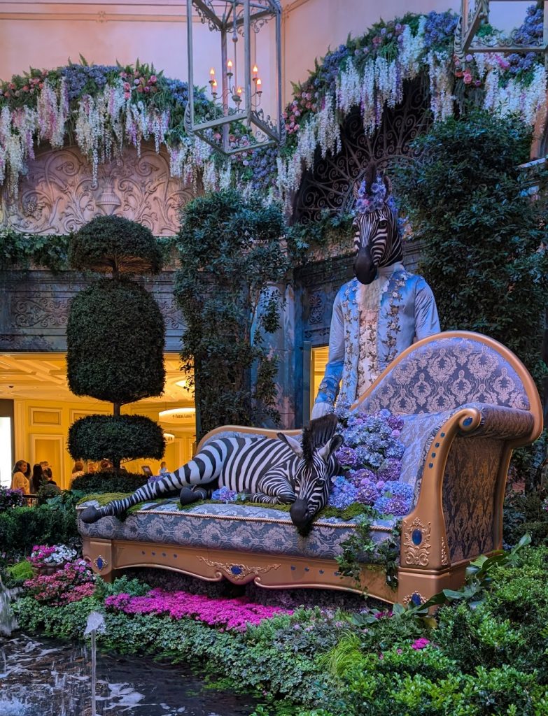 A zebra surrounded by lush topiary at the Bellagio Conservatory. 